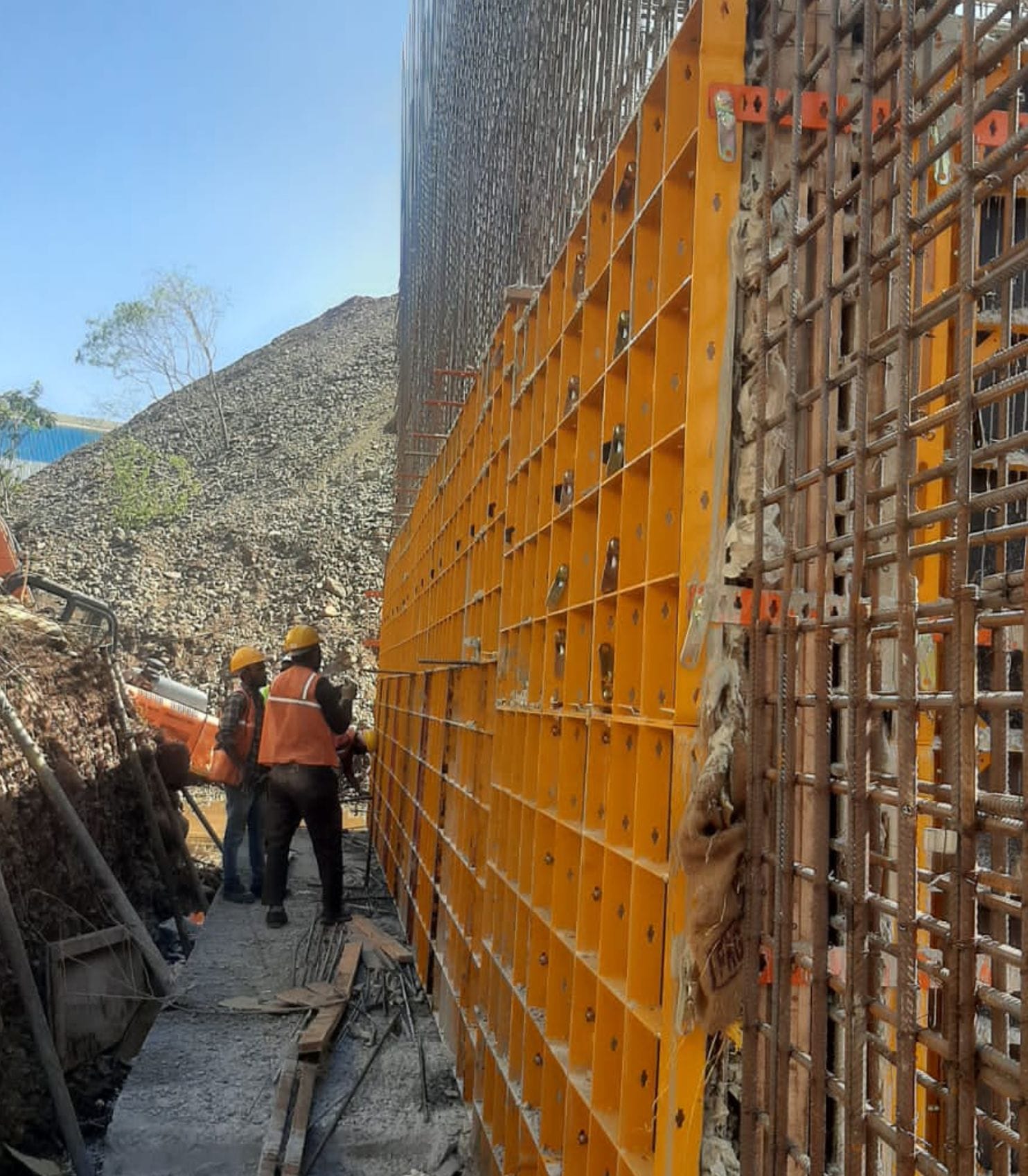 Workers setting wall formwork at the SSC Plant